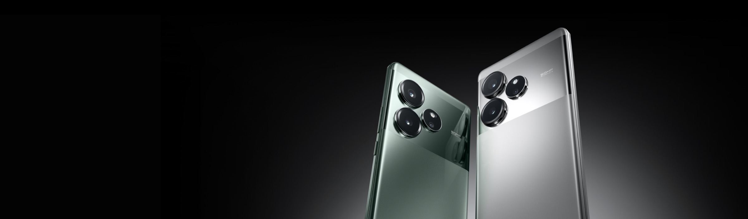 Two realme GT 6 phones, in Fluid Silver and Razor Green, angled back to back showing the triple camera module