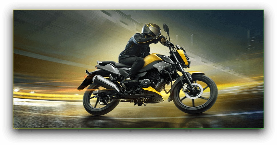 TVS Raider leaning into a corner mid-ride, motion blur in the background